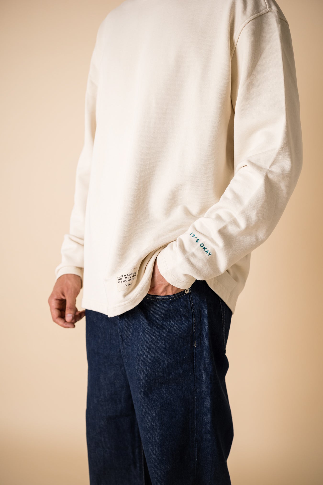 Cultivate what matters crewneck details: Studio photography of sleeve embroidery and iconic it's okay label.